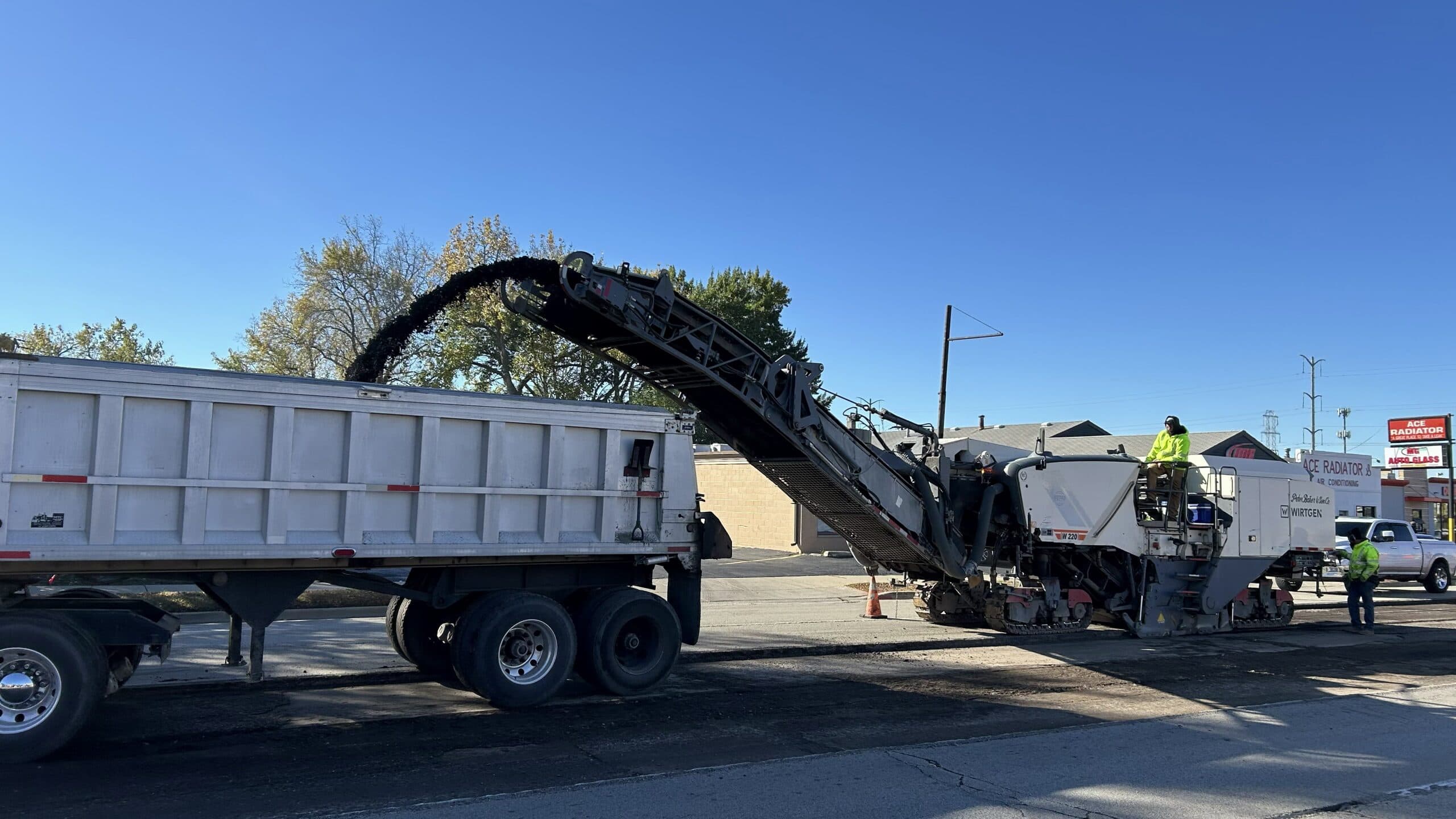 Asphalt paving machine laying new road surface in Waukegan, IL.