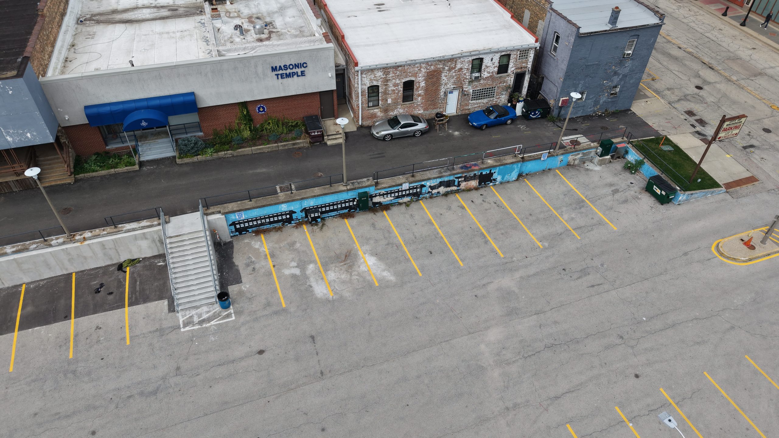 Waukegan IL community infrastructure project with parking lot and train tracks.