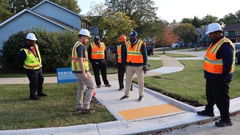 Group of workers inspecting a new pedestrian crosswalk in Waukegan, IL.